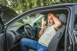 A man on the phone after a truck accident. Steps to take after a truck accident in Washington State.