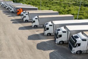 A line of trucks in a parking lot. Who is liable in a commercial truck accident?
